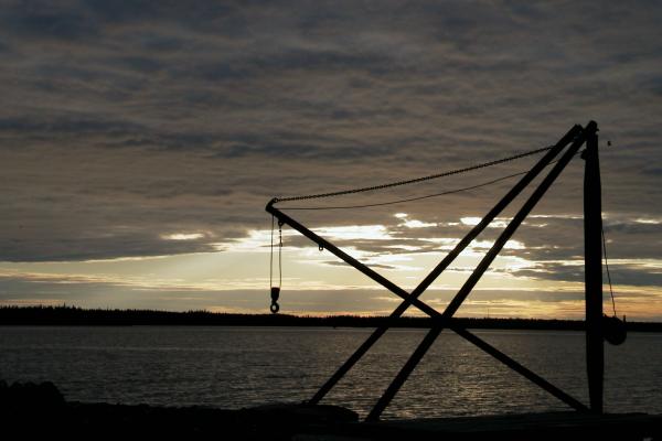 An old crane at the small fishing harbour located near the mainland side of the Replot bridge in Korsholm. On the other side of the strait is the island of Replot.