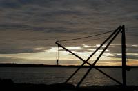 Sunset Photo. An old crane at the small fishing harbour located near the mainland side of the Replot bridge in Korsholm. On the other side of the strait is the island of Replot.